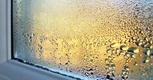 Windowsill and glass covered in condensation water droplets