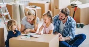 Young happy family moving in new home and choosing colors form palette.