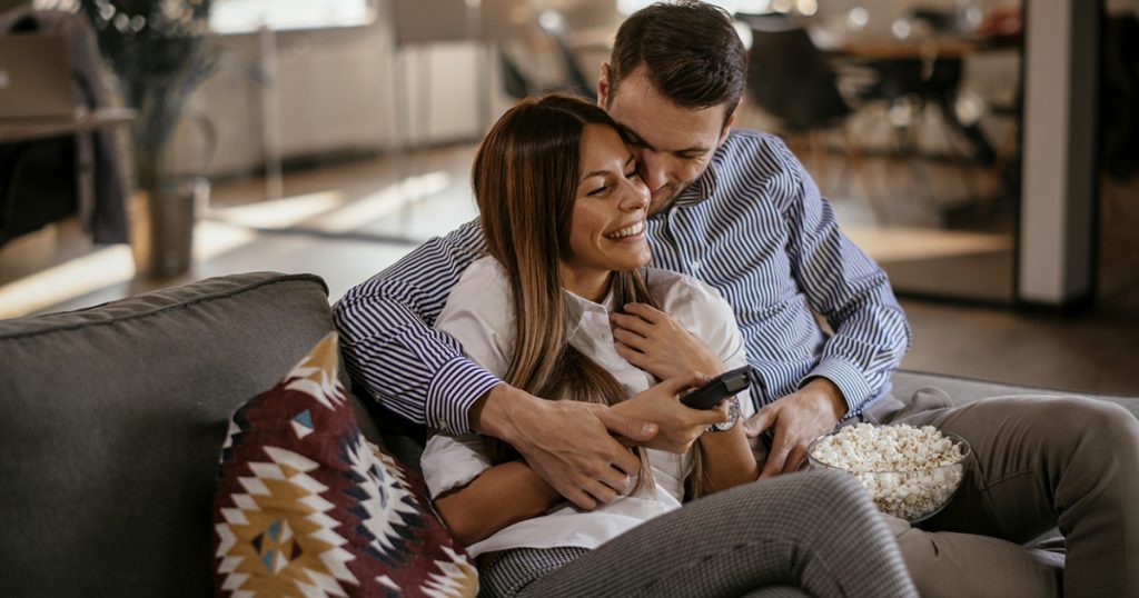 Couple at home watching TV