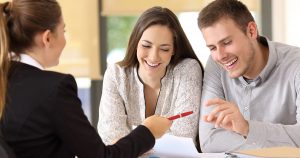 Happy customers ready to sign a contract at office